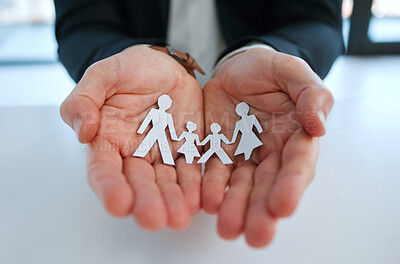 Buy stock photo Shot of a unrecognizable man holding a image of a family in a office