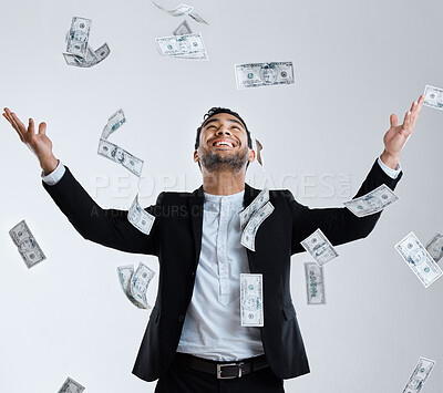 Buy stock photo Studio shot of a well dressed man tossing money up in the air around him