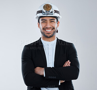 Buy stock photo Shot of a young business man wearing a mining hat against a grey background
