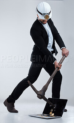 Buy stock photo Shot of a business man mining for bitcoin against a grey background
