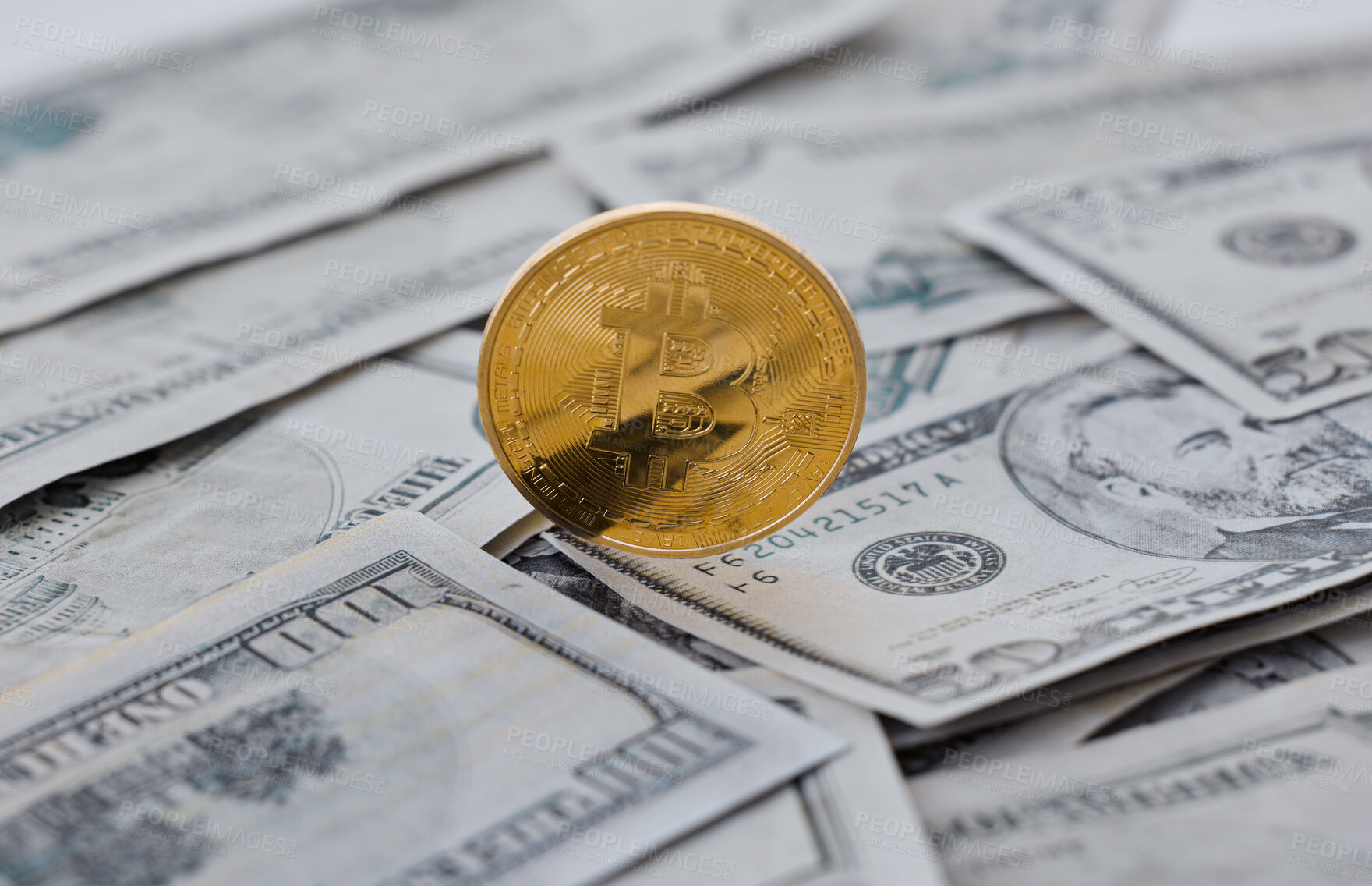 Buy stock photo Shot of a coin and a wad of cash against a grey background