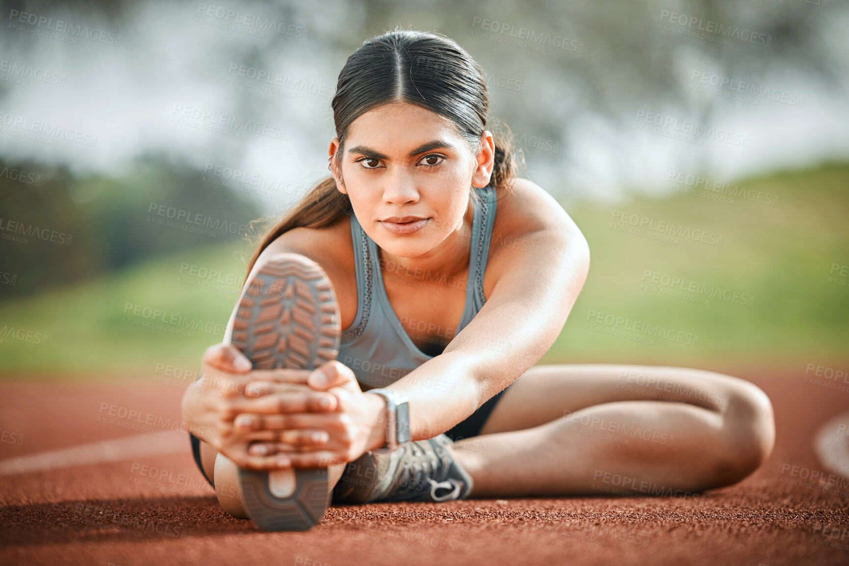 Buy stock photo Girl, stretching leg and athlete portrait on track, outdoor warm up and prepare for start of running. Female person, strong and getting ready for stadium training, flexible and muscle for performance