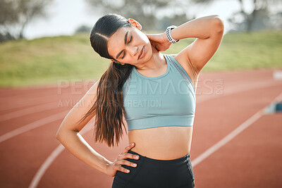 Buy stock photo Shot of a young athlete experiencing neck pain on a running track
