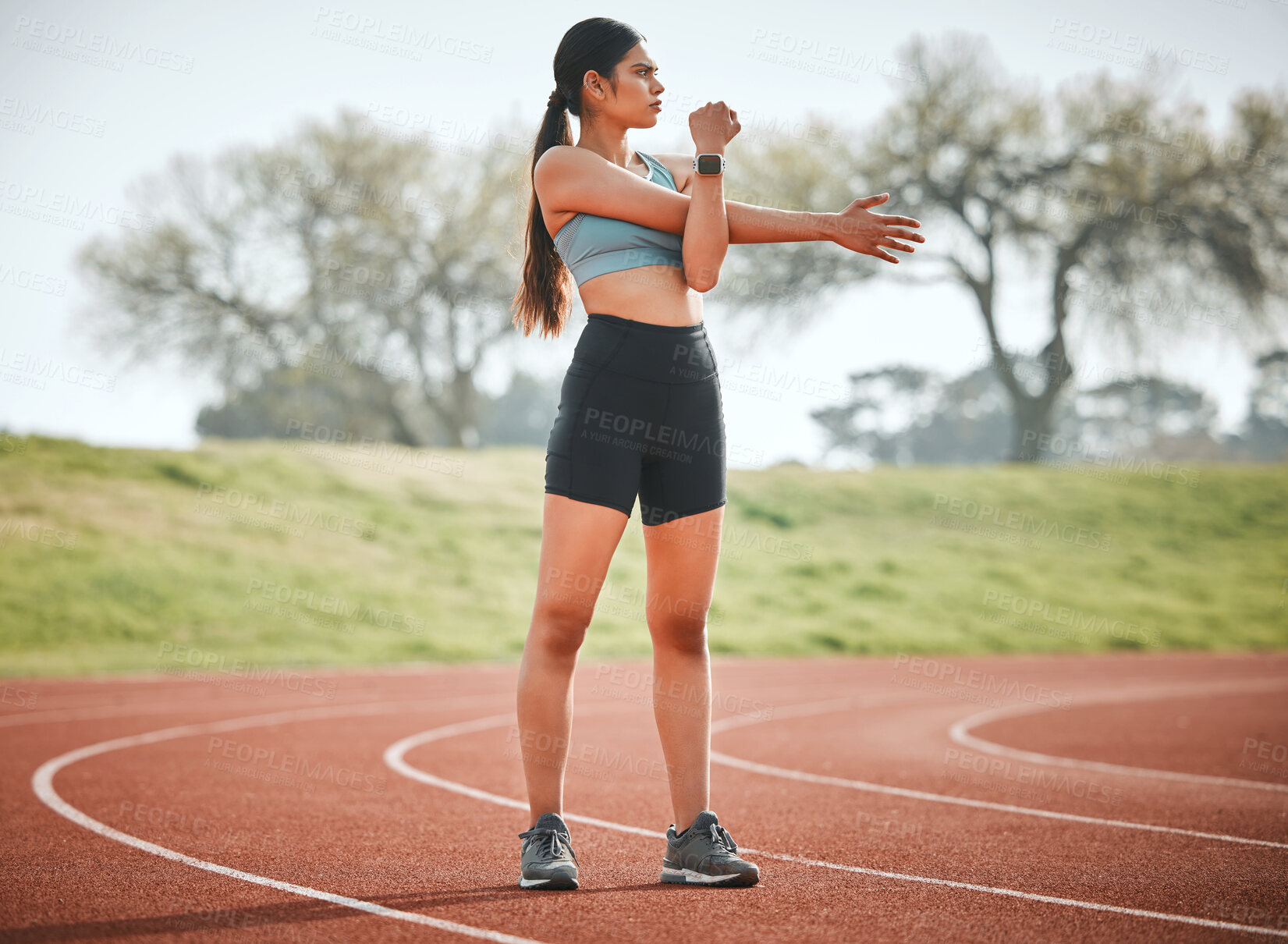 Buy stock photo Girl, stretching arms and athlete on running track, outdoor warm up and prepare for start of cardio. Female person, sports and getting ready for marathon training, flexible and muscle for performance