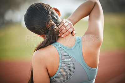 Buy stock photo Rearview shot of a young athlete experiencing neck pain on a running track