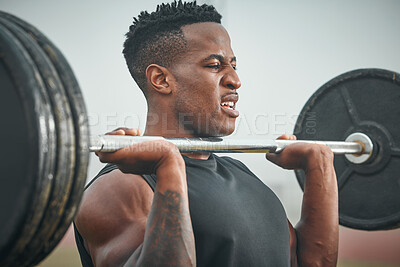 Buy stock photo Shot of a muscular young man exercising with a barbell outdoors