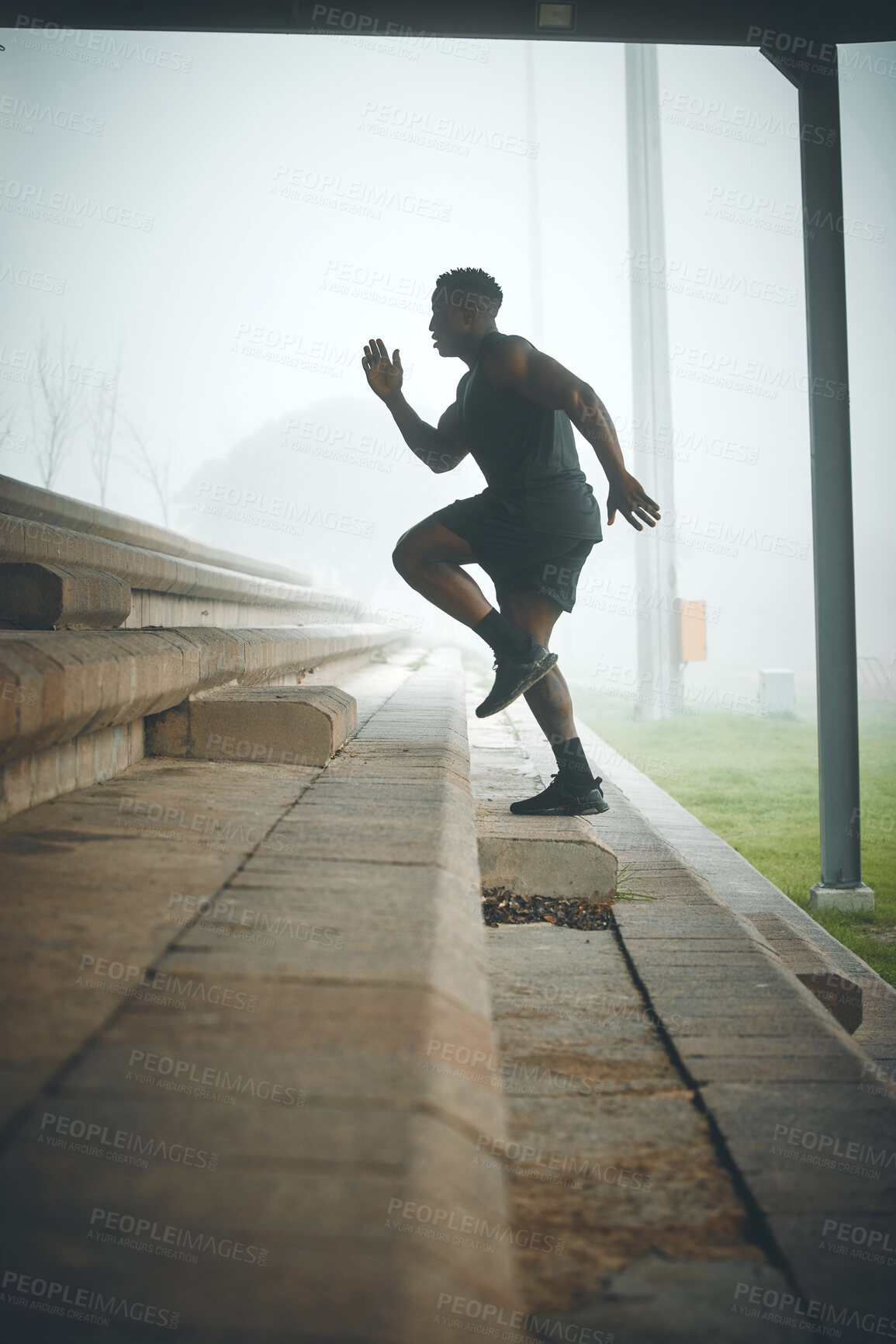 Buy stock photo Man, running and profile on stairs for fitness, health and cardio training to lose weight at stadium. African person, athlete and speed on steps, moving or balance for development with workout in fog