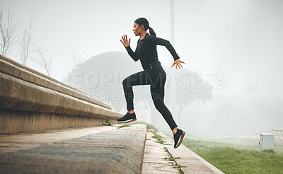 Buy stock photo Shot of a sporty young woman running up steps outdoors