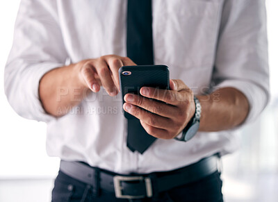 Buy stock photo Shot of a businessman using his smartphone to send a text message