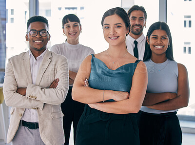 Buy stock photo Shot of a group of young business people together in their office