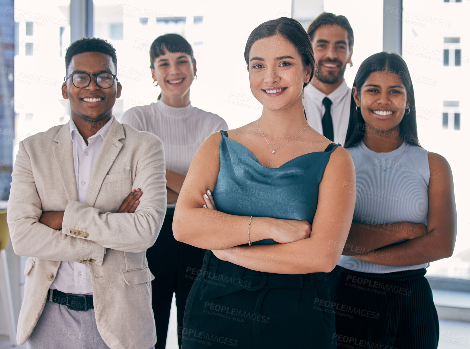 Buy stock photo Shot of a group of young business people together in their office