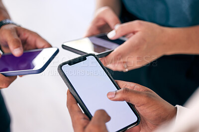 Buy stock photo Shot of a group of business people using their smartphones together