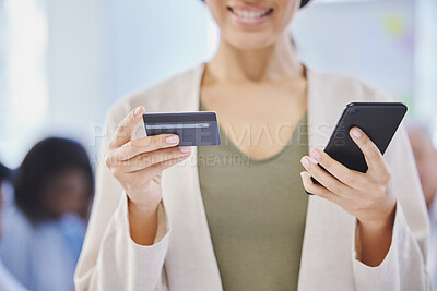 Buy stock photo Cropped shot of a businesswoman using her cellphone and a credit card