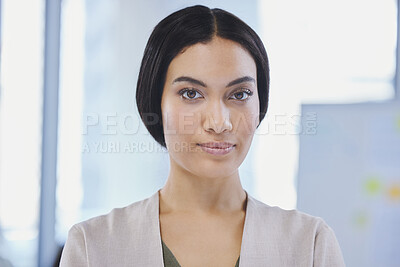 Buy stock photo Shot of a beautiful young businesswoman standing in an office