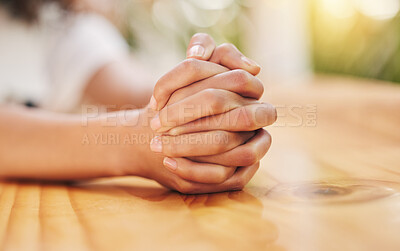 Buy stock photo Shot of a florist sitting with her hands clasped together waiting