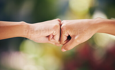 Buy stock photo Shot of two staff members working in a nursery fist bumping one another