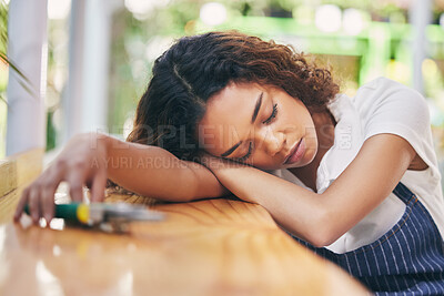 Buy stock photo Shot of a tired nursery owner taking a break from work to nap