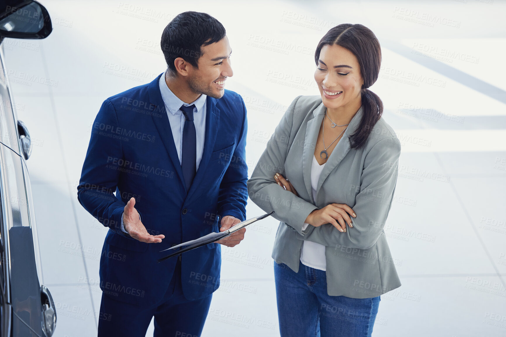 Buy stock photo People, salesman and car dealership with client, pride and clipboard for transport, loan or test drive in automobile. Woman, man and excited in showroom for decision in buying new vehicle in shop
