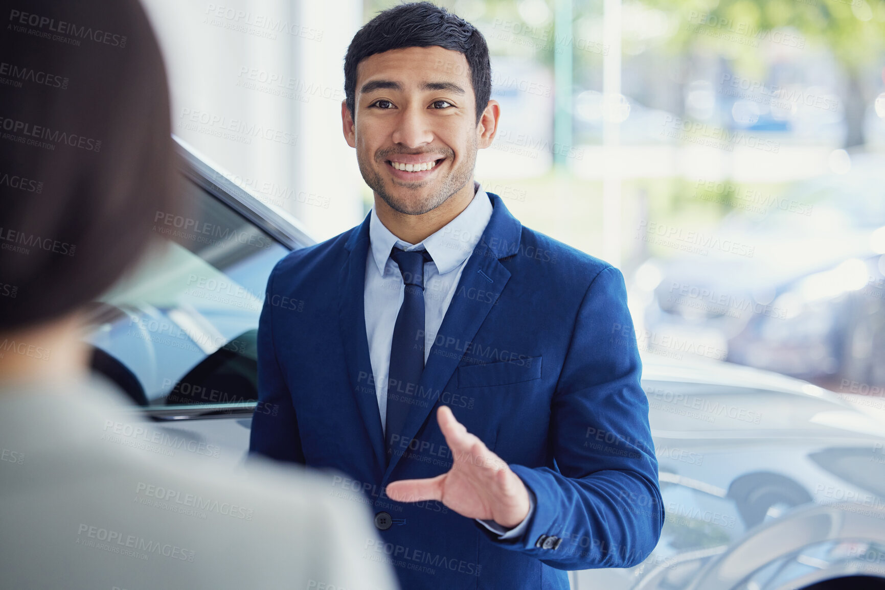 Buy stock photo People, car dealership and salesman with client, pride and confidence for transport, loan or test drive in automobile. Woman, man and excited in showroom for decision in buying new vehicle in shop
