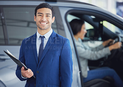 Buy stock photo Documents, portrait and car salesman smile at showroom, workshop or workplace. Face, clipboard and Asian person at dealership for motor vehicle shopping, business and sales manager in retail store.