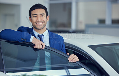 Buy stock photo Cropped portrait of a handsome young male car salesman working on the showroom floor