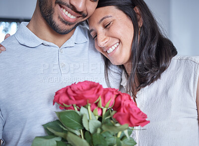 Buy stock photo Love, flowers and couple together in home embrace for romance, connection and communication or support. People, man and woman happy with roses as gift in house for dating, affection and sweet gesture