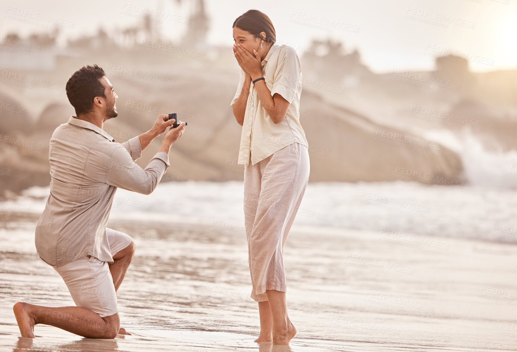 Buy stock photo Couple at beach, wow for proposal and engagement with love and commitment with ocean and people outdoor. Travel, mockup space and man propose marriage to woman, surprise and happiness with care