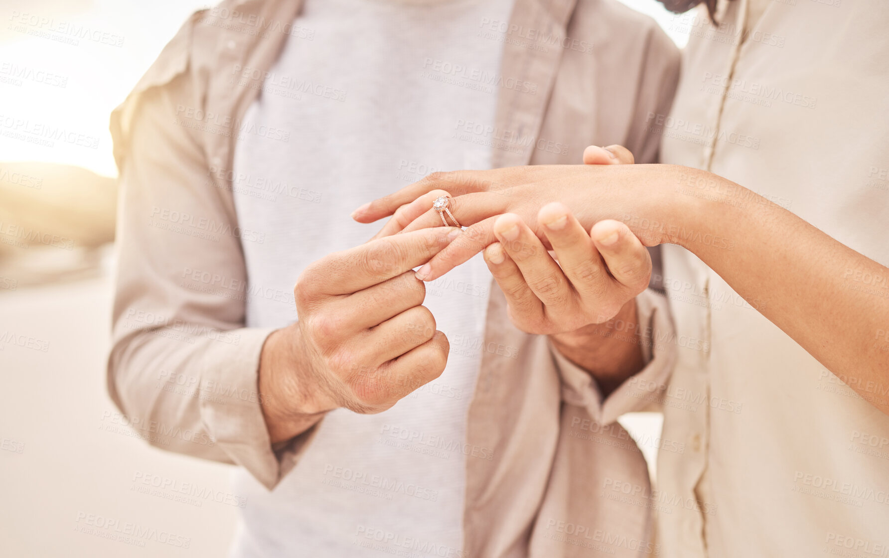 Buy stock photo Couple, hands and engagement in closeup at beach with care, achievement or love on vacation in sunset. Man, woman and ring with marriage offer by ocean for proposal, future and together on holiday