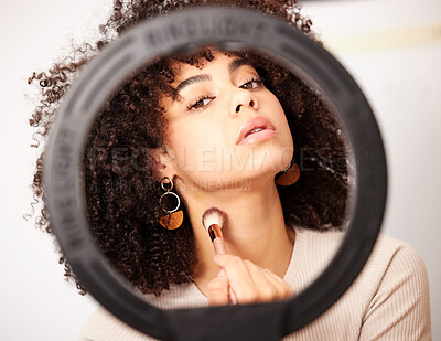 Buy stock photo Shot of a young woman looking into a ring light while doing her make-up