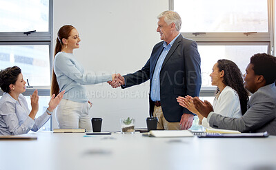 Buy stock photo Shot of two businesspeople shaking hands in a meeting at work