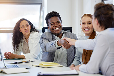 Buy stock photo Shot of two businesspeople shaking hands while in a meeting at work
