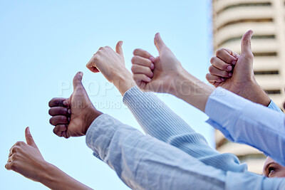 Buy stock photo Low angle shot of a group of unrecognizable businesspeople raising their hands into the air while giving thumbs up