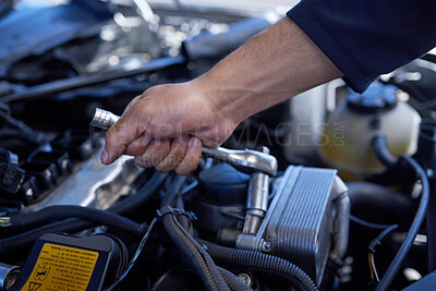 Buy stock photo High angle shot of an unrecognizable male mechanic working on the engine of a car during a service