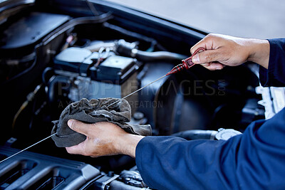 Buy stock photo High angle shot of an unrecognizable male mechanic working on the engine of a car during a service