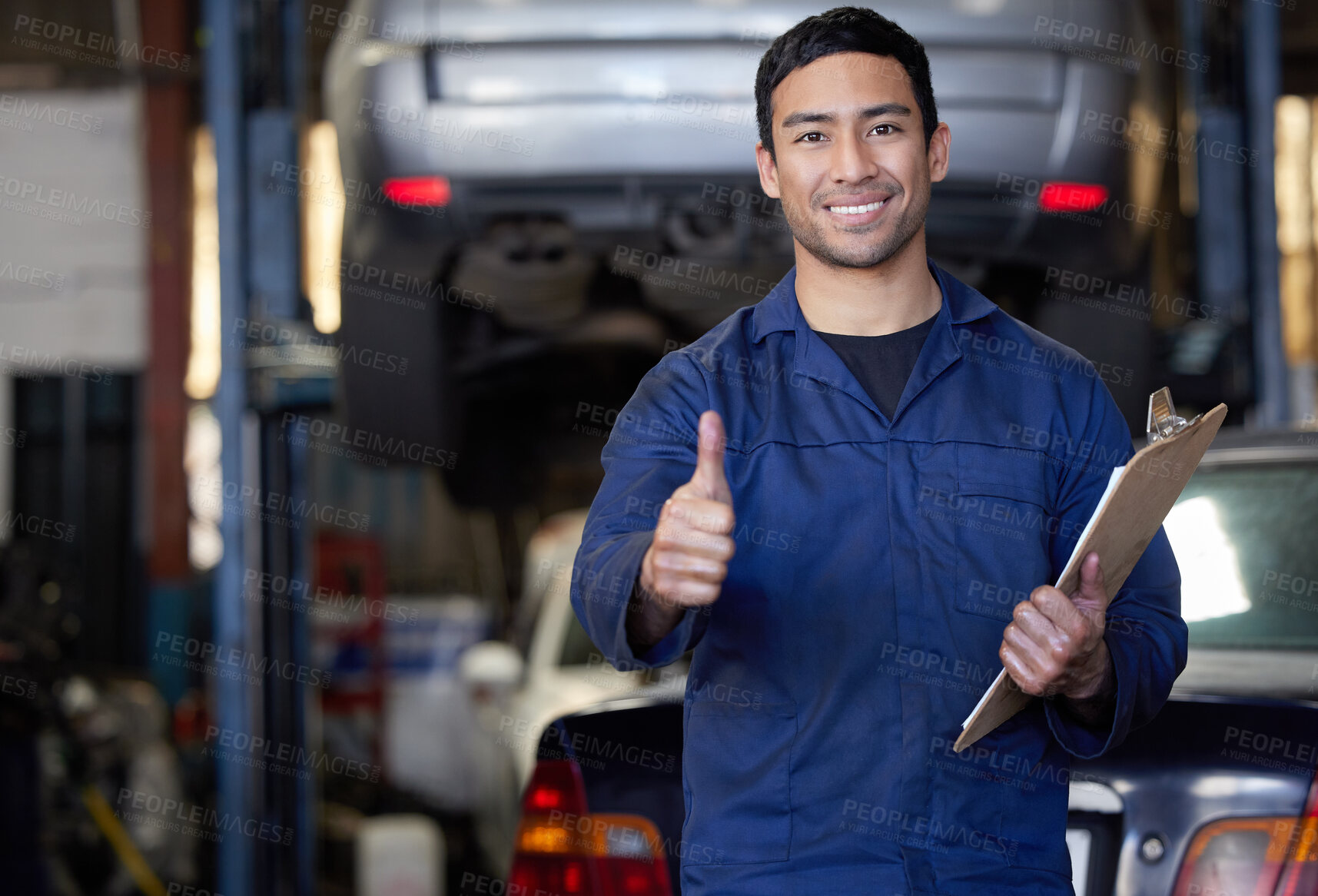 Buy stock photo Man, mechanic and thumbs up in workshop portrait, repair garage and automotive engineering for car maintenance. Good job, vehicle service and motor issues, confident employee and car lift for tuning 