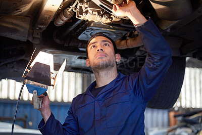 Buy stock photo Man, mechanic and check under car, repair workshop and automotive engineering for car maintenance. Professional, vehicle lift and motor service for issues, exhaust system and suspension inspection