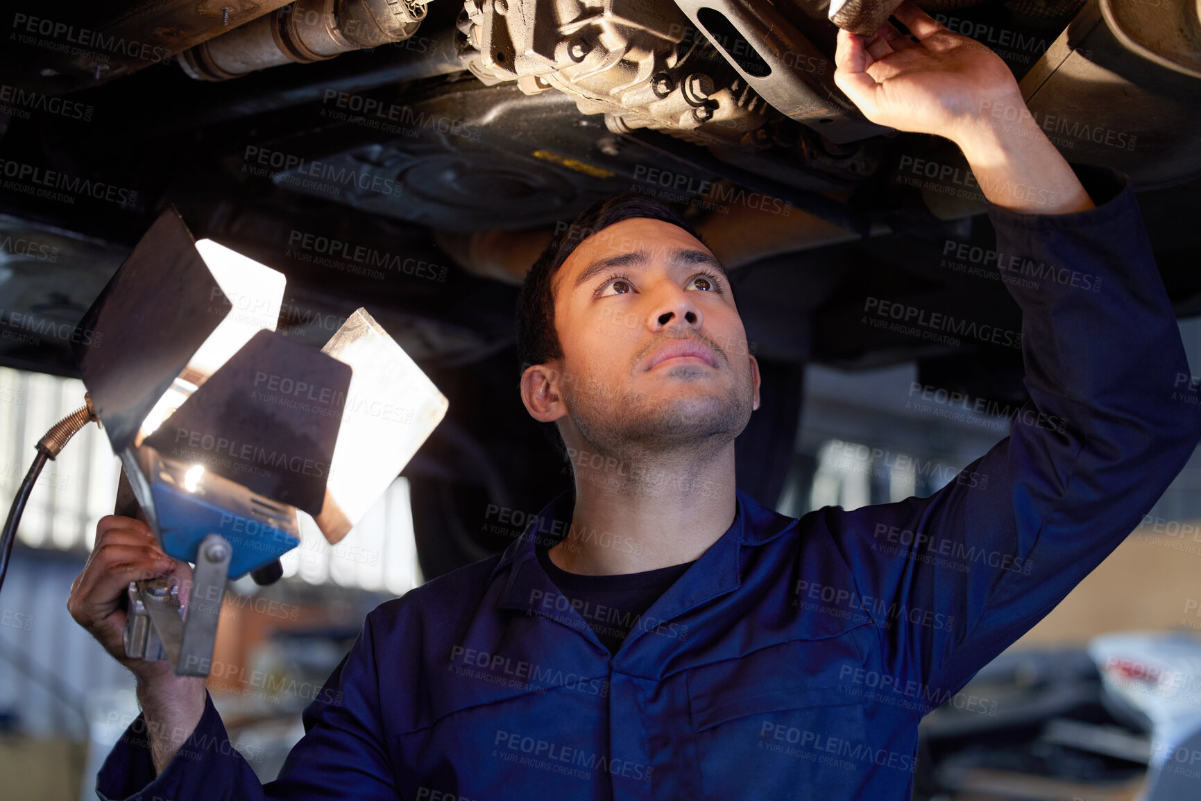 Buy stock photo Man, mechanic and inspection under car, repair workshop and automotive engineering for car maintenance. Professional, vehicle lift and motor service for issues, exhaust system and check suspension