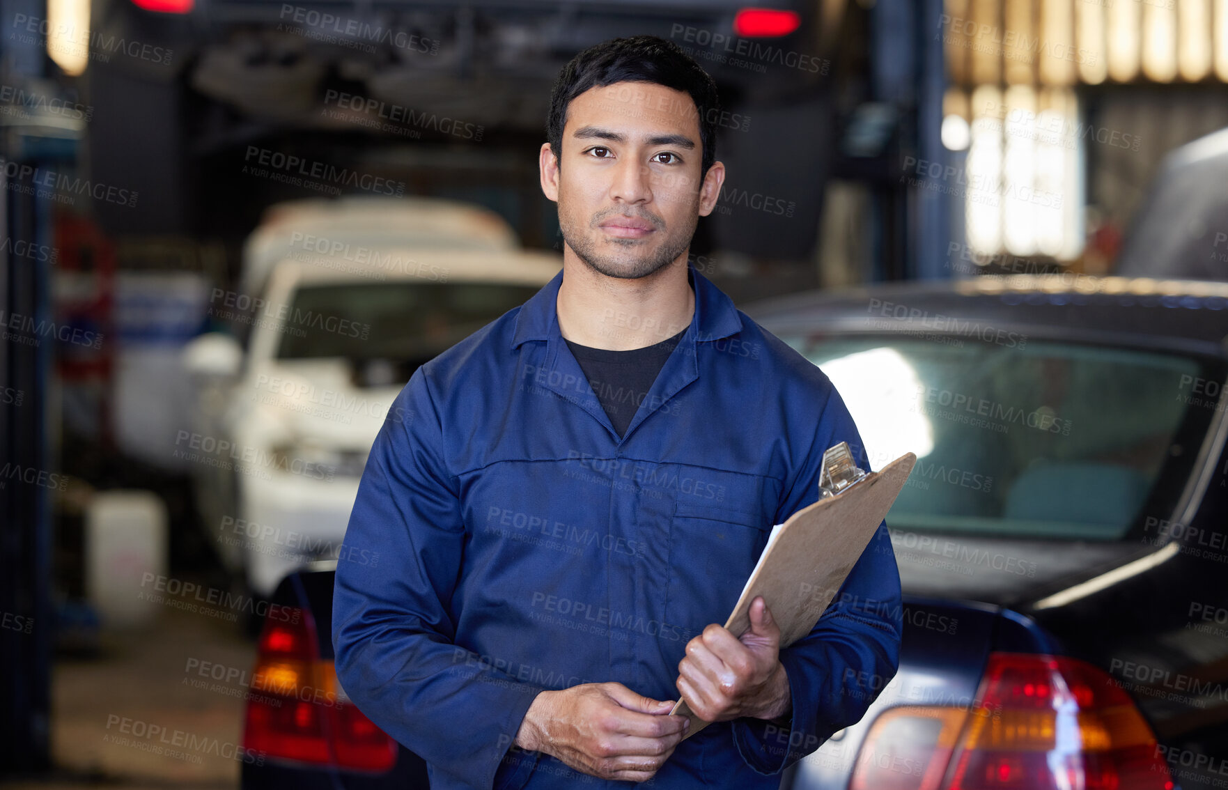 Buy stock photo Serious, man and mechanic with clipboard in car garage for welcome, vehicle repairs and expert advice. Male person or engineer and paperwork in workshop for routine service or automobile maintenance