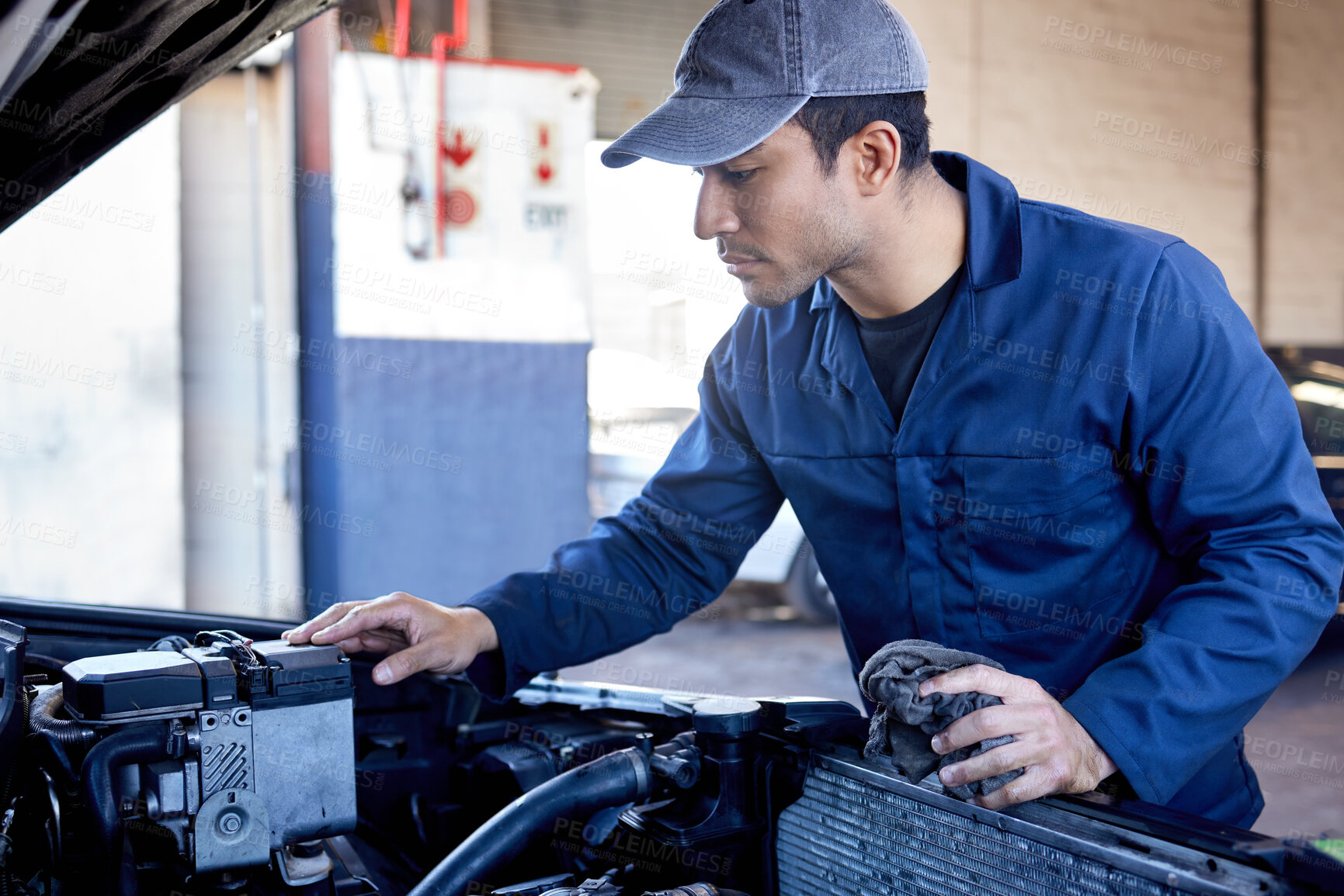 Buy stock photo Male mechanic, inspection and engine with cloth for service in garage, workshop or maintenance on car. Man, auto and check for problem with oil or motor, technician with knowledge on transport
