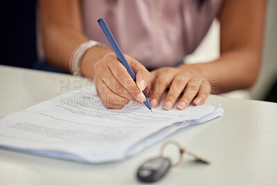 Buy stock photo Shot of a young woman signing paperwork