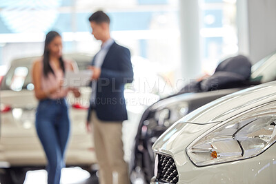 Buy stock photo Shot of a salesman assisting a young woman on the showroom floor