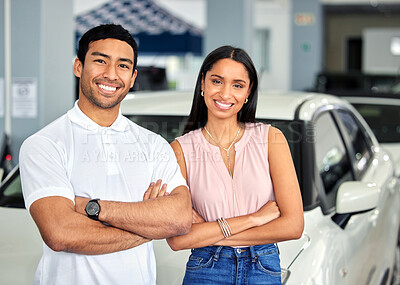 Buy stock photo Shot of a young couple at a car dealership