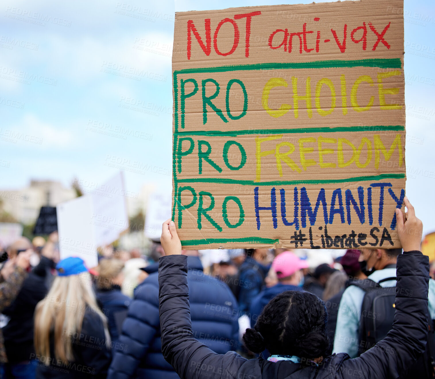 Buy stock photo Unrecognisable demonstrators holding up signs and protesting against the Covid 19 vaccine