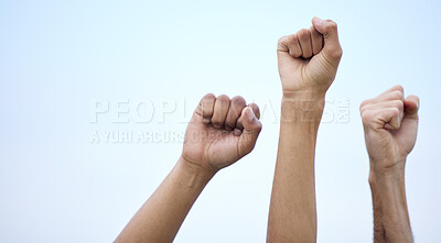 Buy stock photo Unrecognisable demonstrators holding up their fists in protest