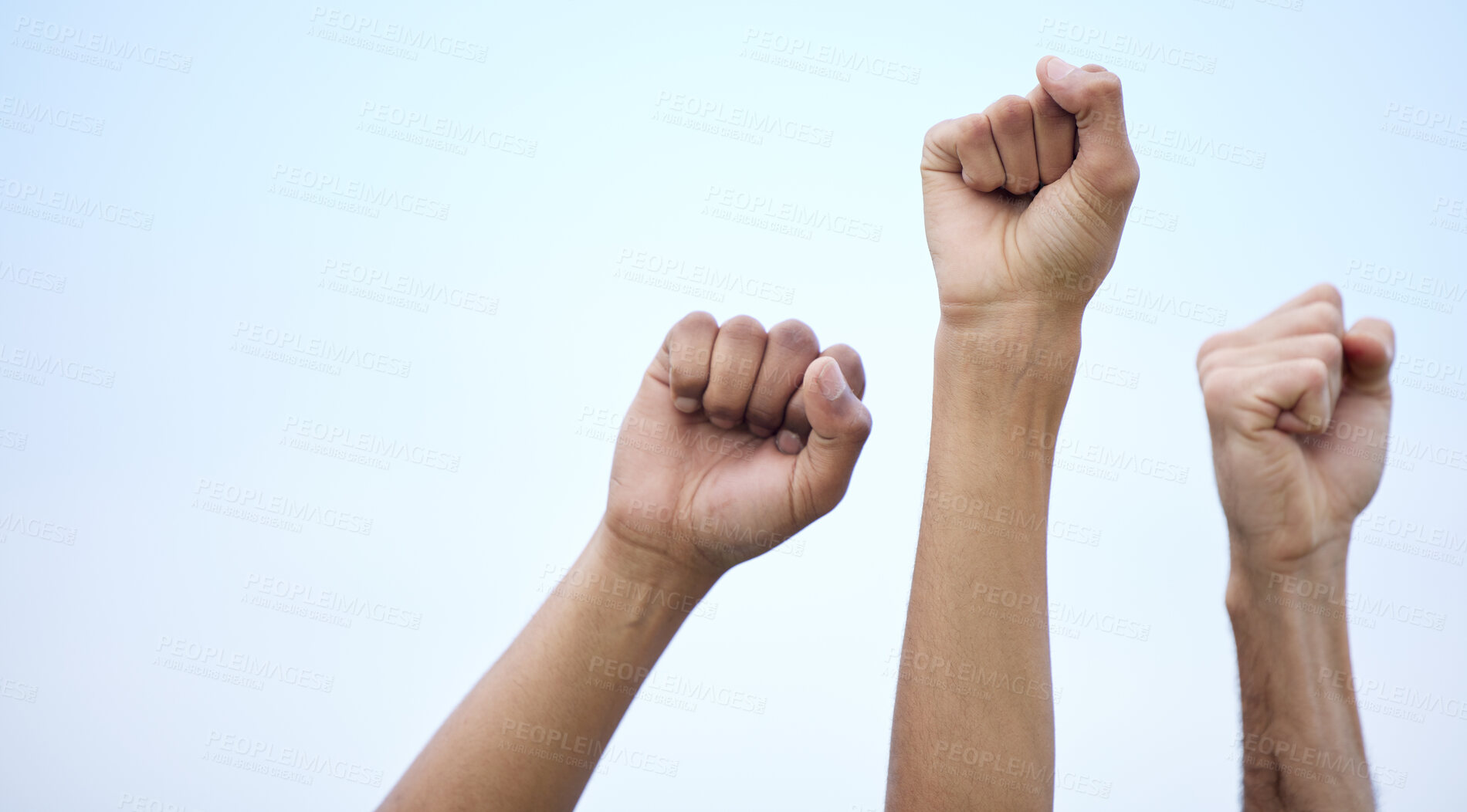 Buy stock photo Unrecognisable demonstrators holding up their fists in protest