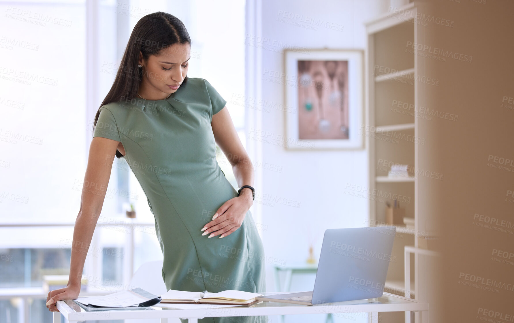 Buy stock photo Business, woman and pregnant pain by desk for contractions, muscle ache and tension in lower stomach for hard kick. Mother to be, stress and hand on abdomen for pressure, discomfort and fatigue.