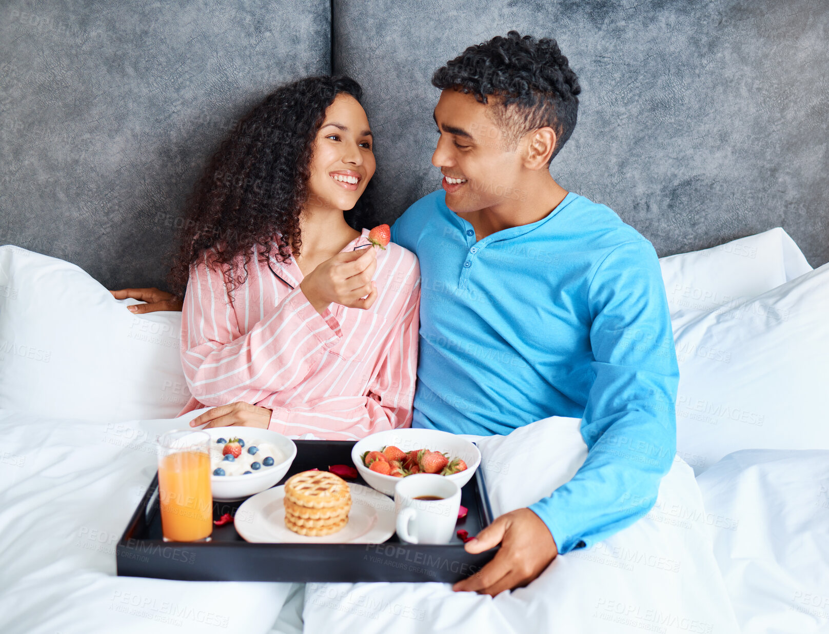 Buy stock photo Happy, couple and breakfast in bedroom for love, care and eating or sharing on weekend morning. People, man and woman together in home with smile and food for health, nutrients and relationship