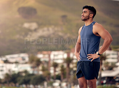 Buy stock photo Shot of a sporty young man looking thoughtful while exercising outdoors