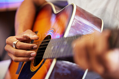 Buy stock photo Cropped shot of an unrecognizable male musician playing his guitar at home