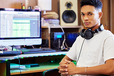 Buy stock photo Cropped portrait of a handsome young male music producer working in his home office
